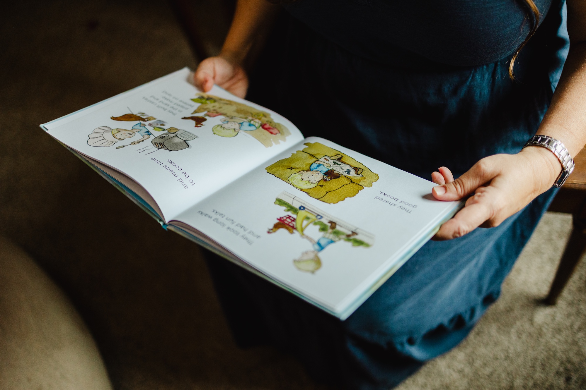 An open copy of A Boy and His Girl showing its watercolor illustrations